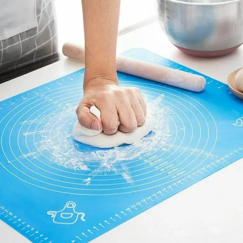 Blue silicone baking mat with measurement markings for dough kneading